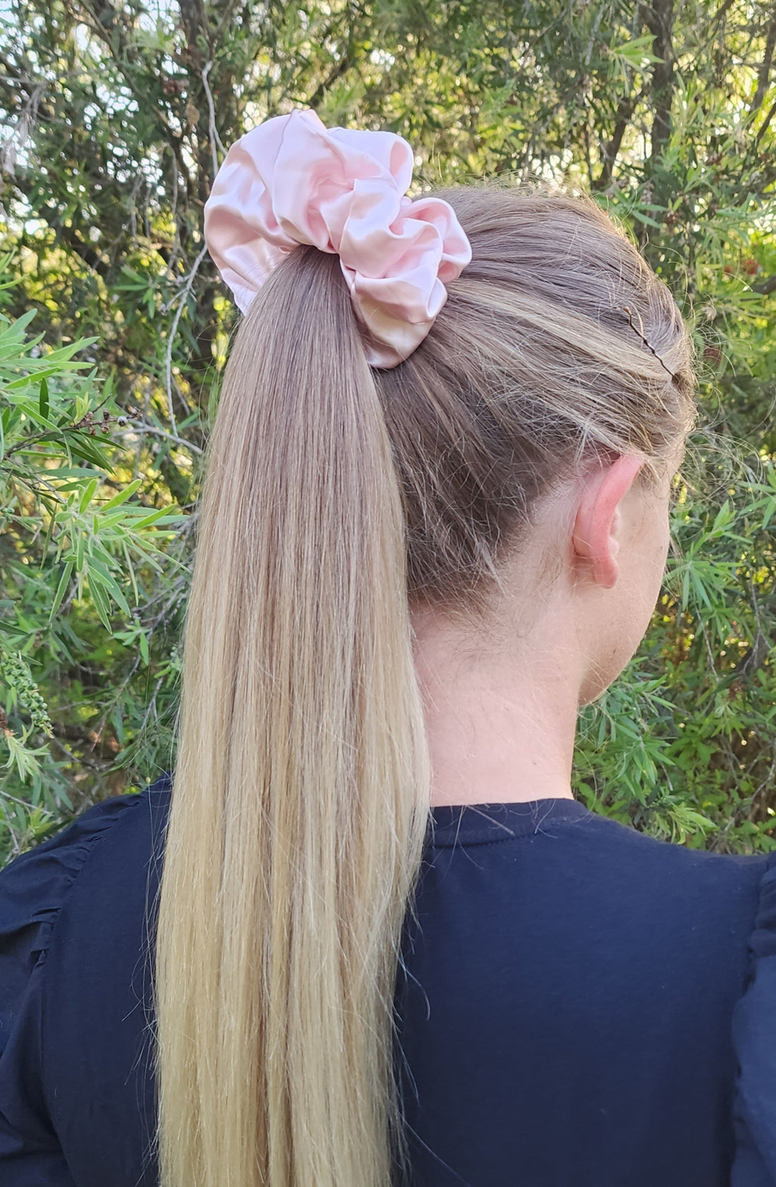 Sugar Kiss oversized mulberry silk scrunchie in soft pink worn in a blonde ponytail outdoors