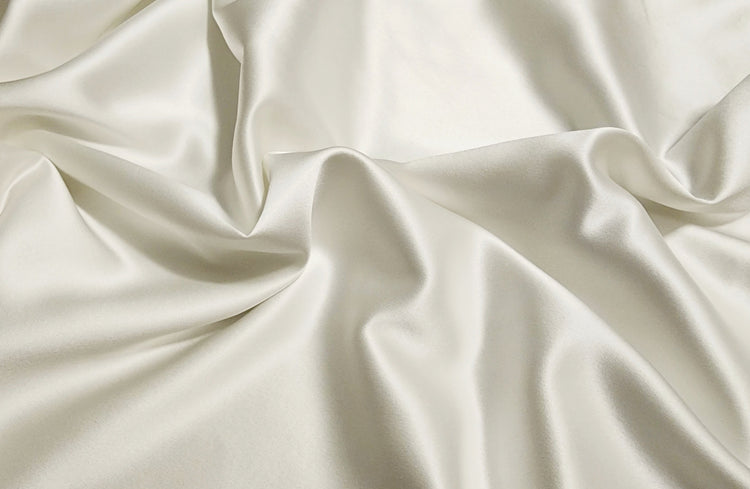 Close-up of real ivory mulberry silk fabric in soft folds
