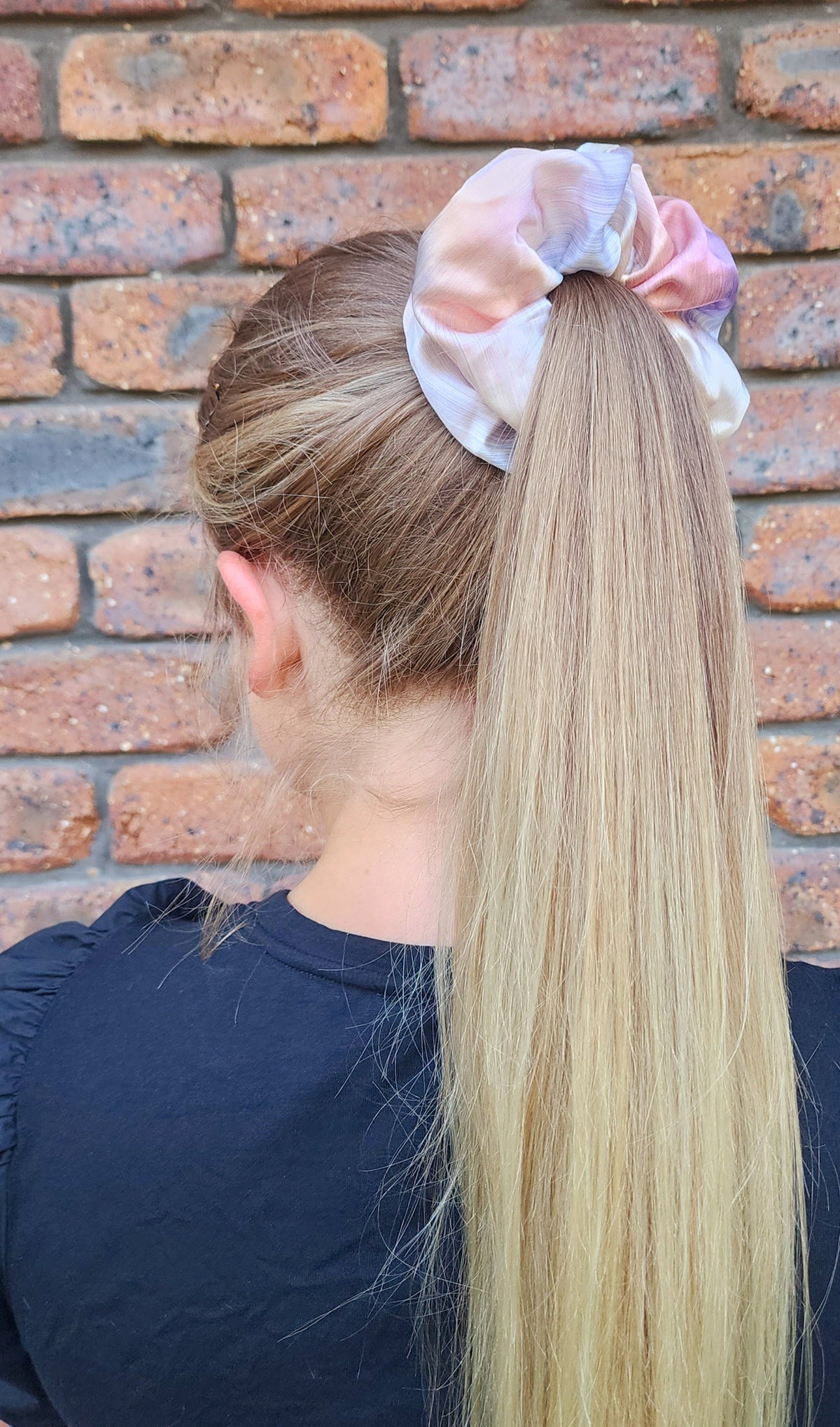 Daydream Oversized silk scrunchie worn around a blonde ponytail