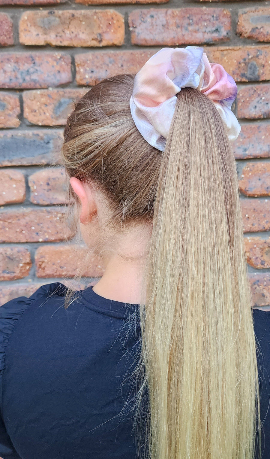 Daydream Oversized silk scrunchie worn around a blonde ponytail