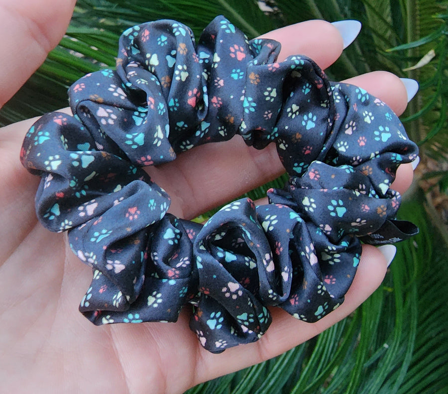 Little Paws printed mulberry silk scrunchie held in a hand