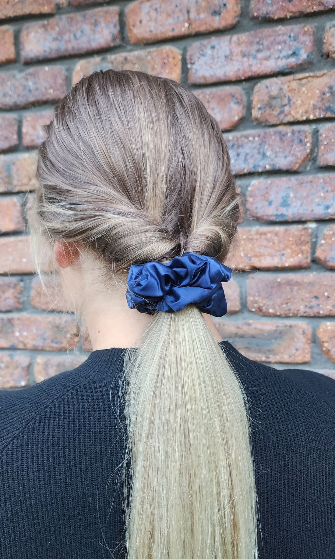 Midnight Tide classic mulberry silk scrunchie in navy blue worn in a blonde ponytail outdoors