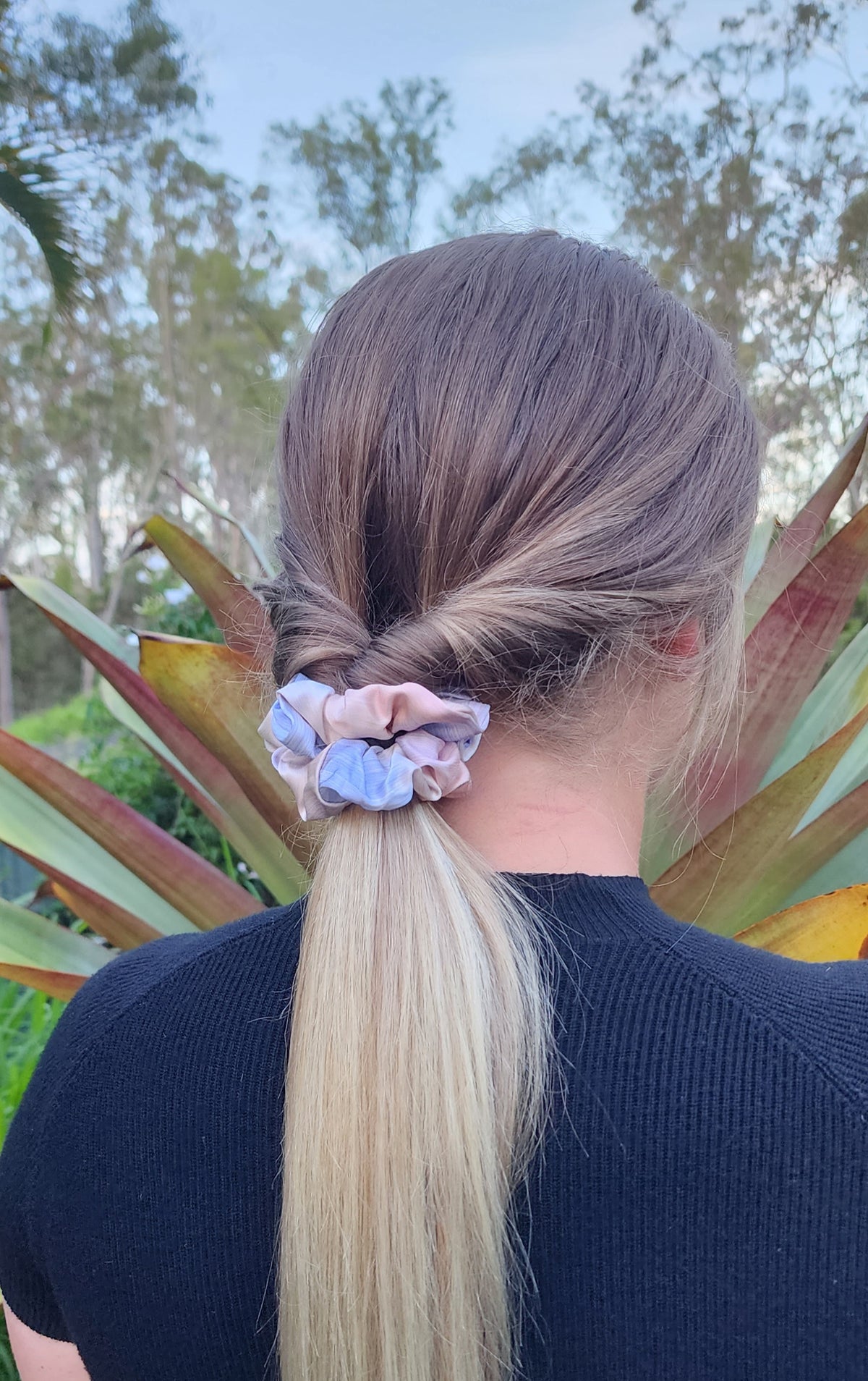 Daydream classic mulberry silk scrunchie in pastel blue, pink and cream worn in a blonde ponytail outdoors