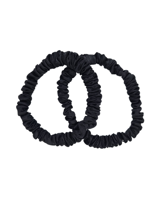 Pair of thin black mulberry silk scrunchies on white background – premium 1cm silk hair ties by The Scrunchie Vault, gentle and sleek for Australian women’s hair care.