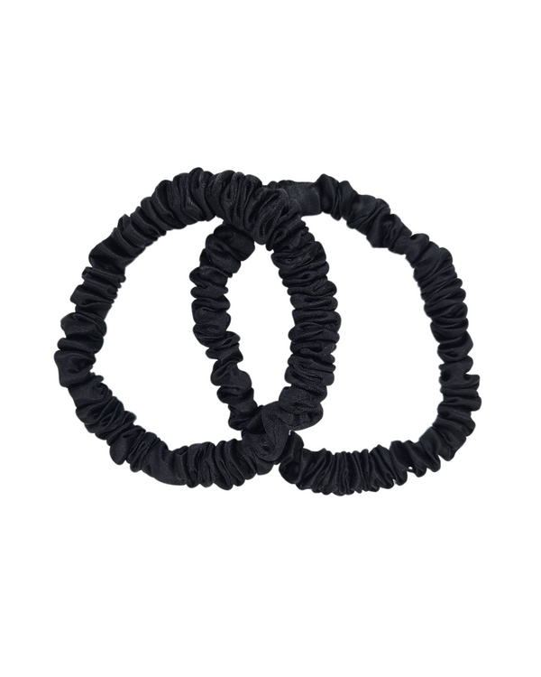 Two Onyx thin mulberry silk scrunchies in black on a white background