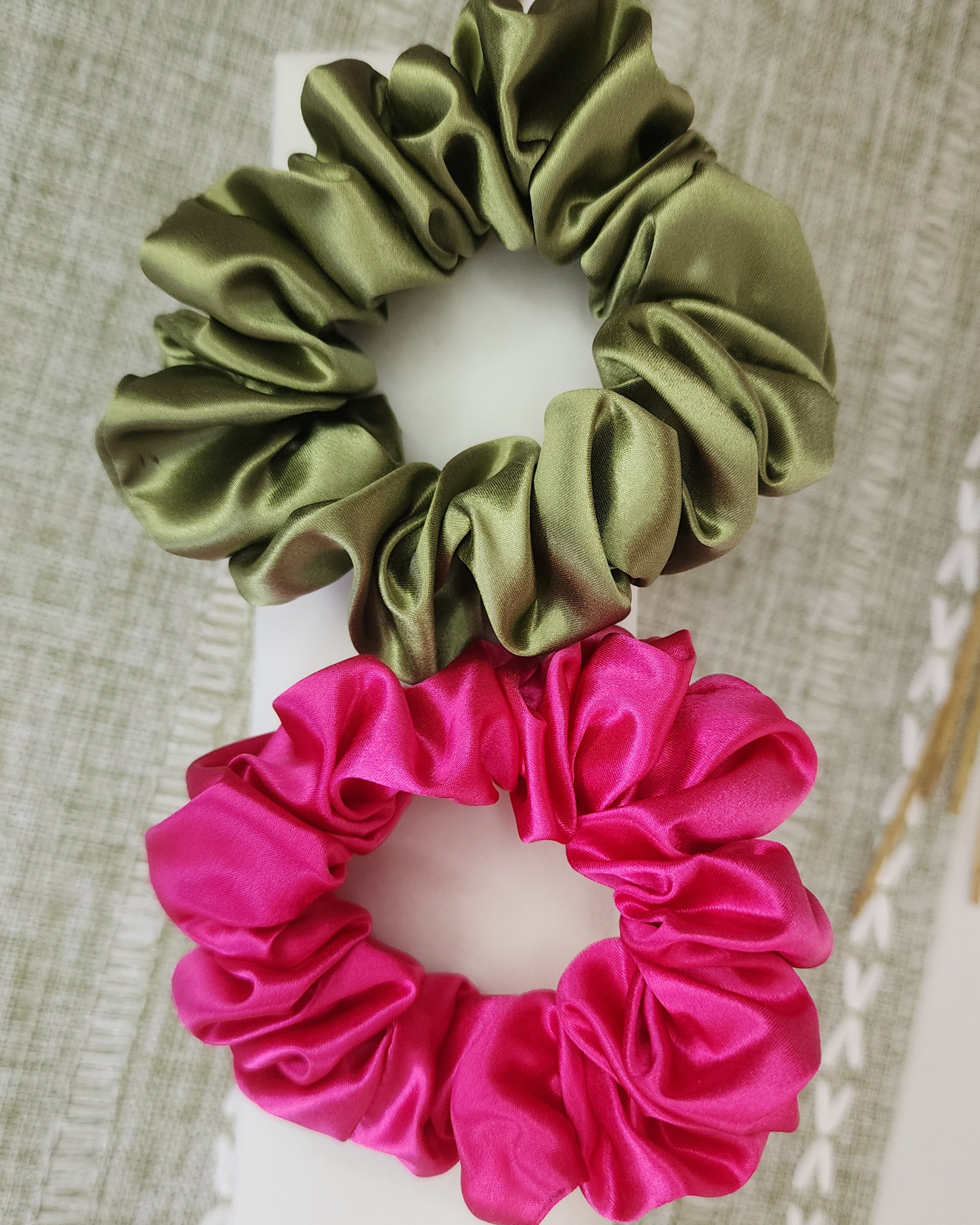 Everyday Essentials Set – two coloured 22 momme Mulberry Silk scrunchies displayed together on a neutral-toned buffet unit, styled for a soft, elegant lifestyle look.